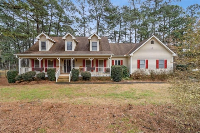 new england style home featuring a front lawn and a porch