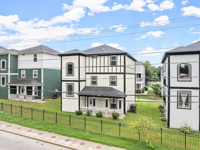 exterior space with a front yard, central air condition unit, and covered porch