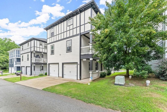 exterior space with a balcony, a garage, and a front yard