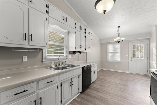 kitchen with sink, black dishwasher, a textured ceiling, white cabinets, and decorative light fixtures