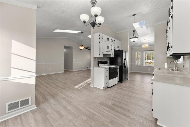 kitchen with hanging light fixtures, white electric range, white cabinets, and a textured ceiling