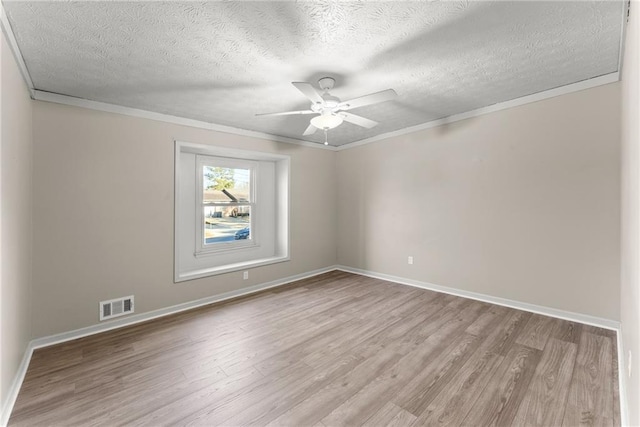 empty room with crown molding, light hardwood / wood-style flooring, and ceiling fan