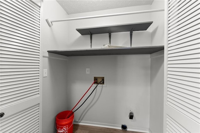 laundry area featuring hookup for a washing machine, wood-type flooring, and a textured ceiling