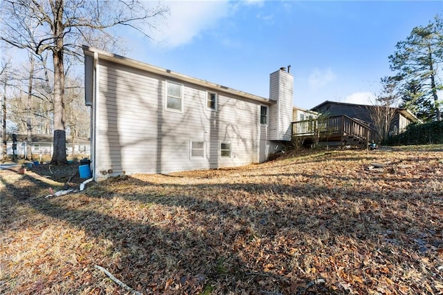 back of property featuring a wooden deck