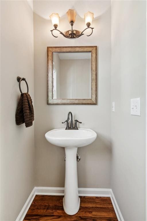 bathroom with baseboards and wood finished floors