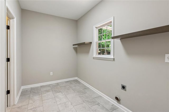 clothes washing area featuring baseboards, hookup for an electric dryer, laundry area, and marble finish floor