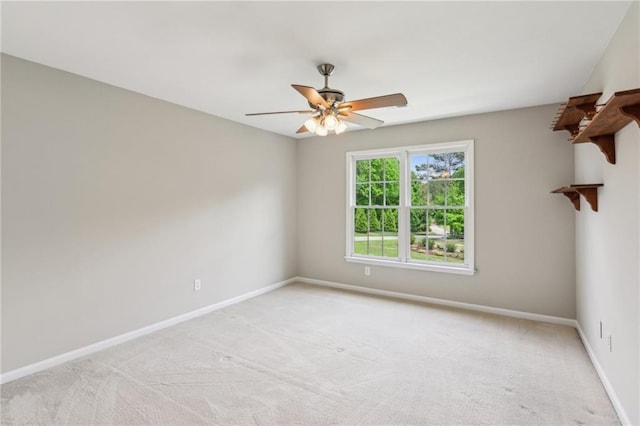 unfurnished room featuring baseboards, ceiling fan, and light colored carpet