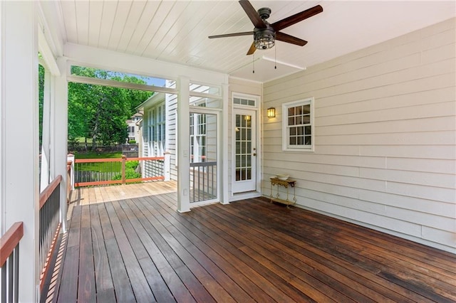 unfurnished sunroom with ceiling fan