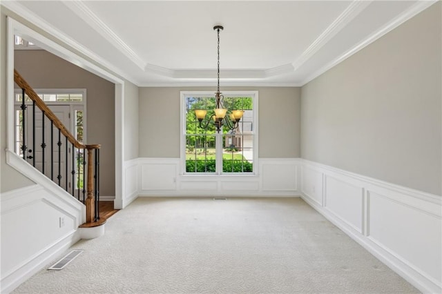 unfurnished dining area featuring visible vents, stairs, light colored carpet, a raised ceiling, and a chandelier
