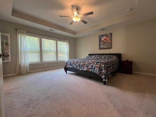 239 Lenore Ct, Hiram, GA 30141 - carpeted bedroom with a raised ceiling and a ceiling fan