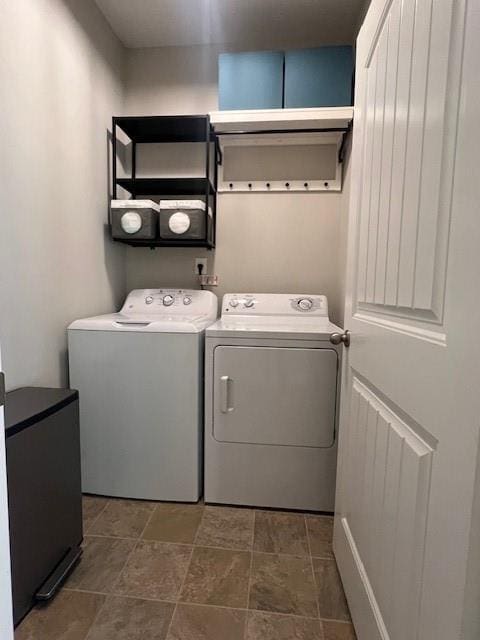 239 Lenore Ct, Hiram, GA 30141 - washroom with independent washer and dryer and dark stone finish flooring