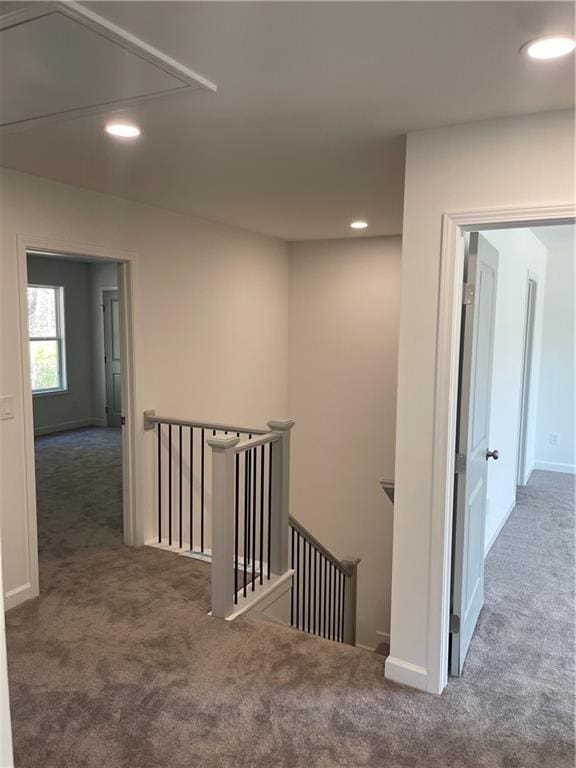 corridor with an upstairs landing, carpet flooring, recessed lighting, and baseboards