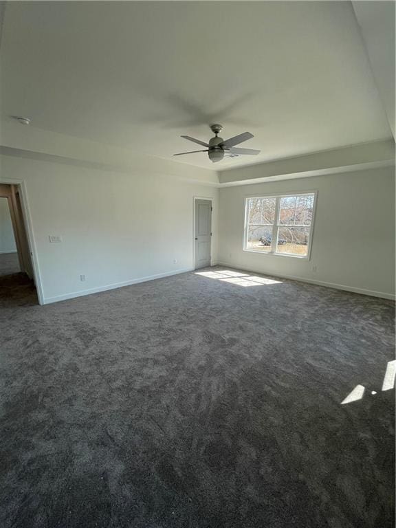 unfurnished room with carpet flooring and baseboards