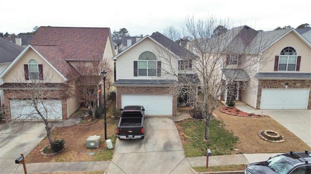 view of front of house with a garage, brick siding, and driveway