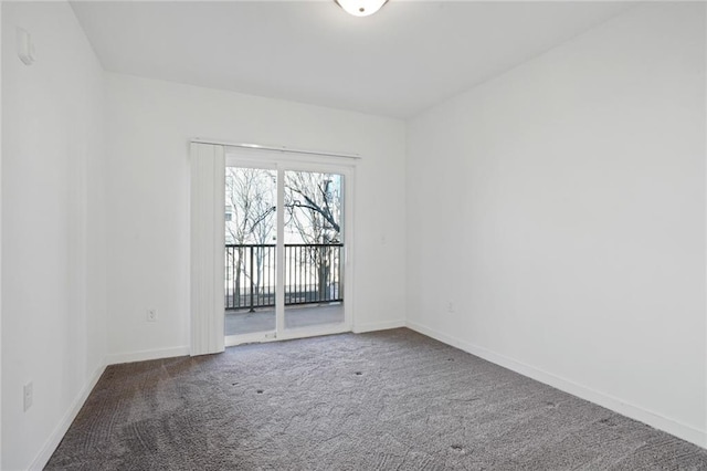 unfurnished room with dark colored carpet