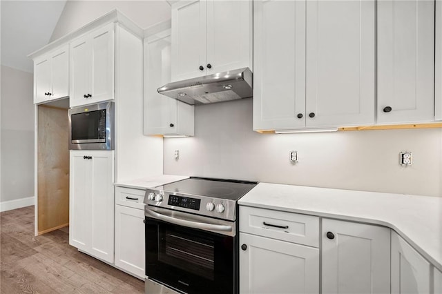 kitchen featuring light wood-type flooring, appliances with stainless steel finishes, and white cabinets