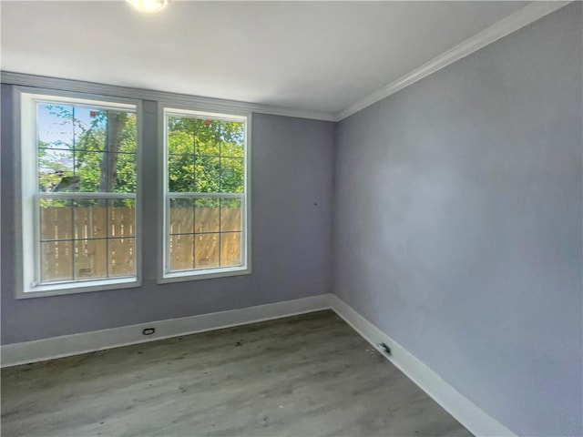 spare room with hardwood / wood-style flooring, plenty of natural light, and crown molding