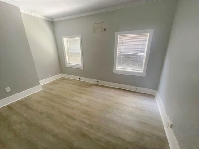 unfurnished room featuring light wood-type flooring and ornamental molding