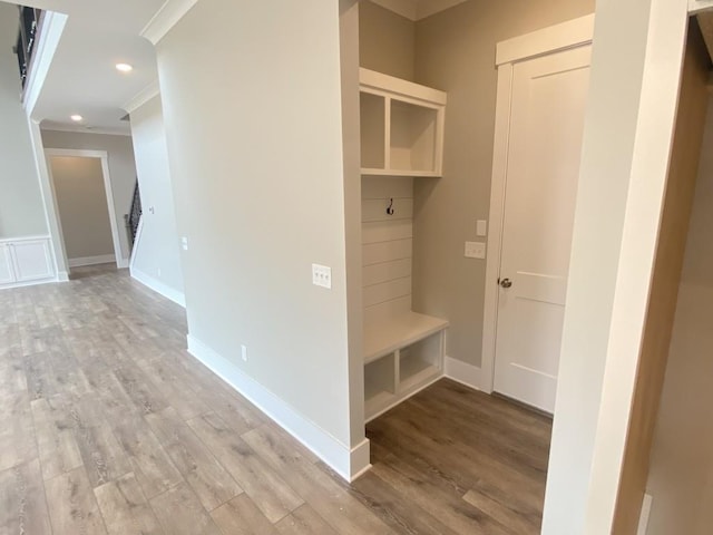 mudroom with recessed lighting, crown molding, light wood-style flooring, and baseboards