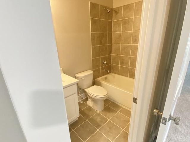 bathroom with toilet, vanity,  shower combination, and tile patterned floors