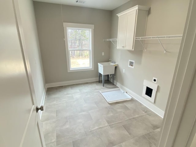 laundry room with hookup for a washing machine, visible vents, baseboards, cabinet space, and electric dryer hookup