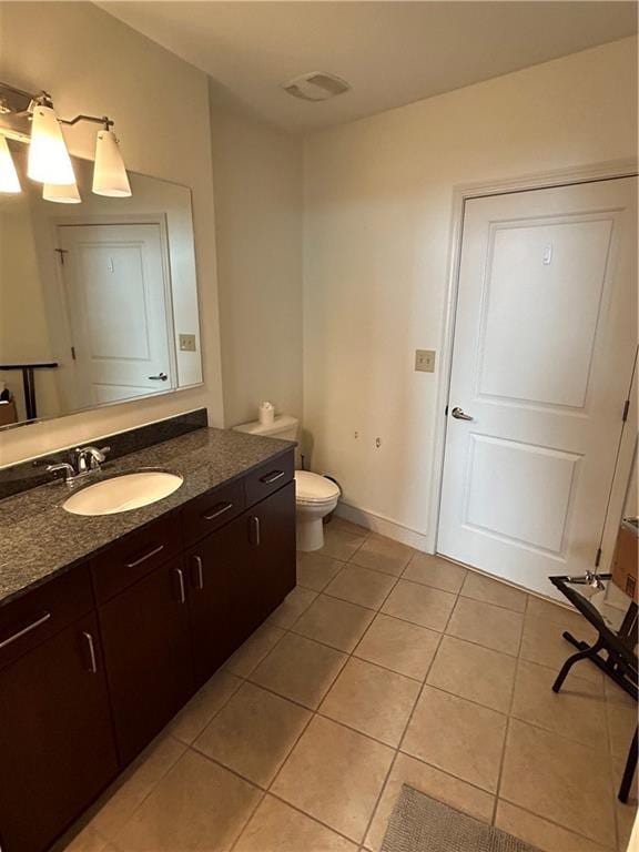 bathroom with tile patterned floors, toilet, and vanity