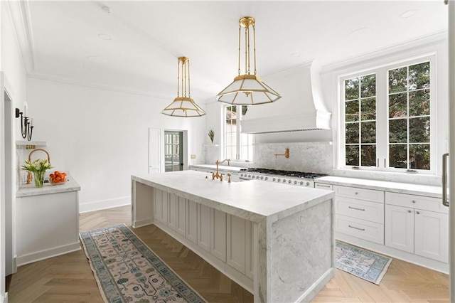 3051 Habersham Rd NW, Atlanta, GA 30305 - kitchen with an island with sink, crown molding, tasteful backsplash, premium range hood, and white gas stove
