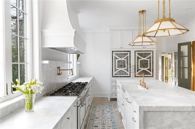 3051 Habersham Rd NW, Atlanta, GA 30305 - kitchen with a center island with sink, high end stainless steel range, decorative backsplash, and a wealth of natural light