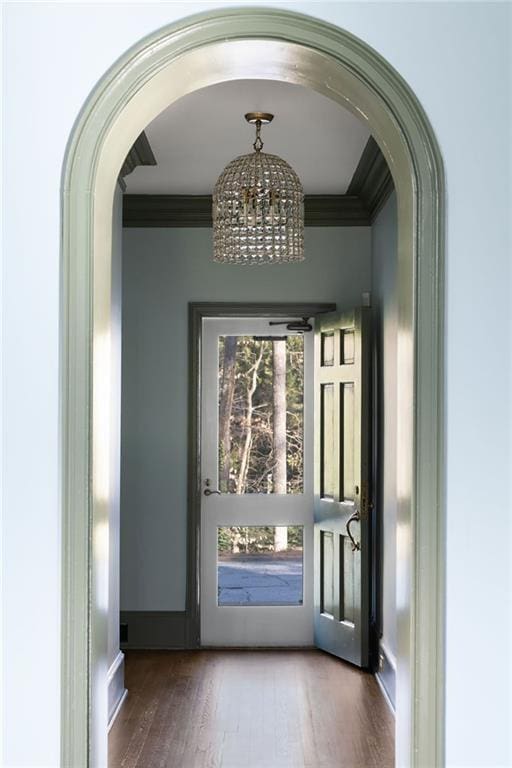 3051 Habersham Rd NW, Atlanta, GA 30305 - doorway with crown molding, a chandelier, wood finished floors, baseboards, and arched walkways