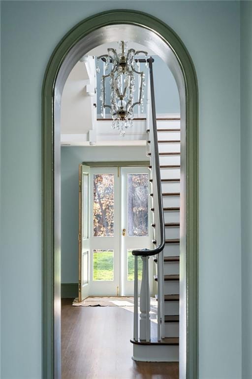 3051 Habersham Rd NW, Atlanta, GA 30305 - entrance foyer with arched walkways, a notable chandelier, and wood finished floors
