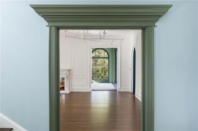 3051 Habersham Rd NW, Atlanta, GA 30305 - hallway with baseboards, a chandelier, crown molding, and dark wood finished floors