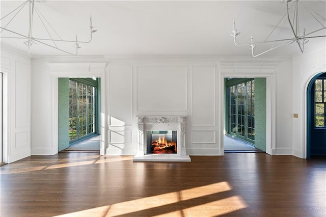 3051 Habersham Rd NW, Atlanta, GA 30305 - unfurnished living room with crown molding, a decorative wall, and an inviting chandelier