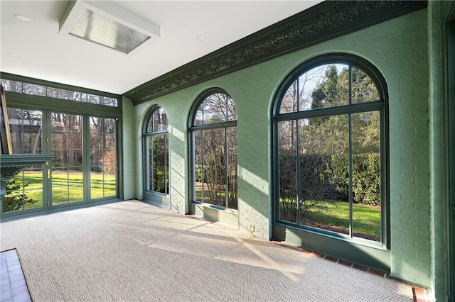 3051 Habersham Rd NW, Atlanta, GA 30305 - unfurnished sunroom featuring carpet and brick wall