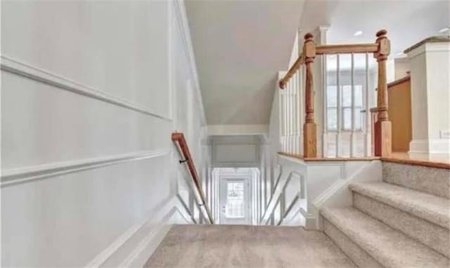 stairs with carpet and lofted ceiling