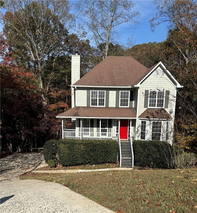 view of front of house featuring a porch and a front yard