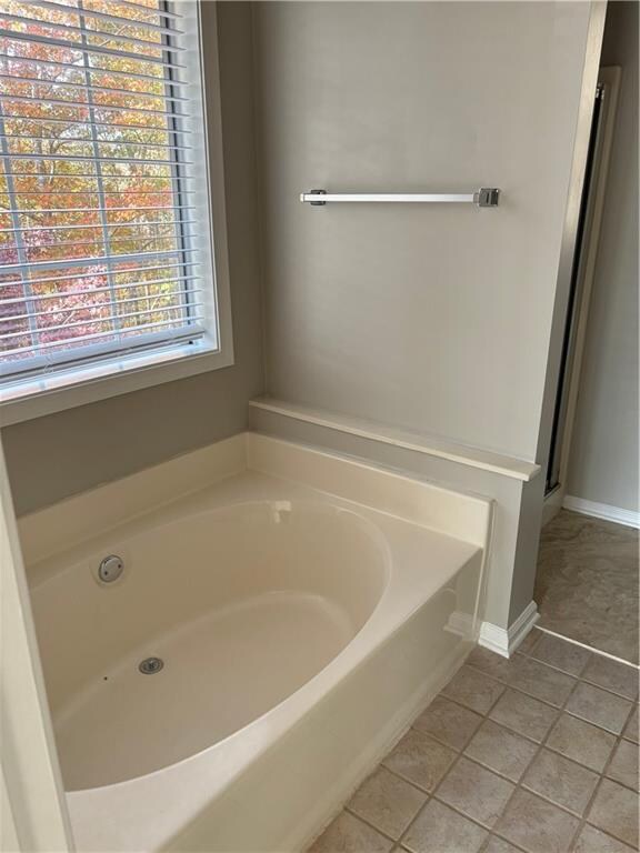 bathroom featuring tile patterned floors and a bathing tub