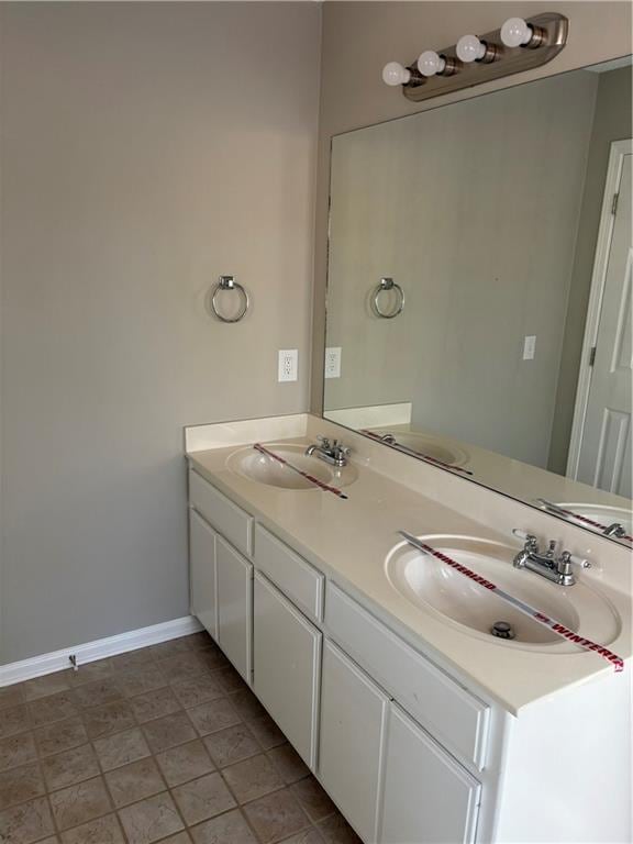 bathroom with tile patterned floors and vanity