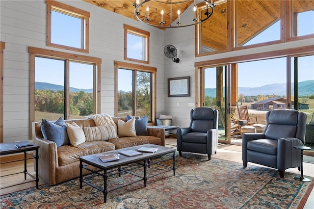 living room featuring a mountain view, a chandelier, and a high ceiling