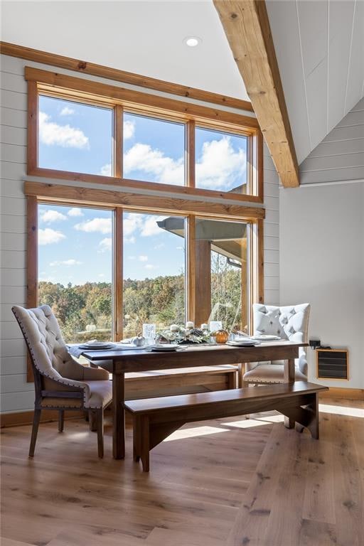 living area featuring lofted ceiling, a wealth of natural light, and hardwood / wood-style floors