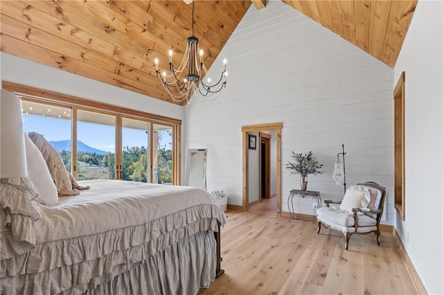 bedroom featuring light hardwood / wood-style flooring, a notable chandelier, high vaulted ceiling, and wooden ceiling