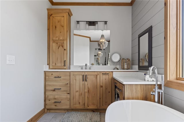 bathroom with a washtub, tile floors, vanity, and crown molding