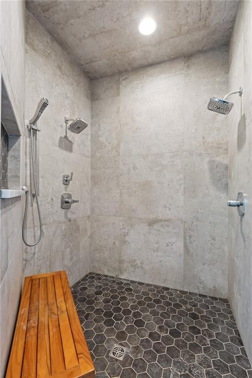 bathroom featuring a tile shower and tile floors