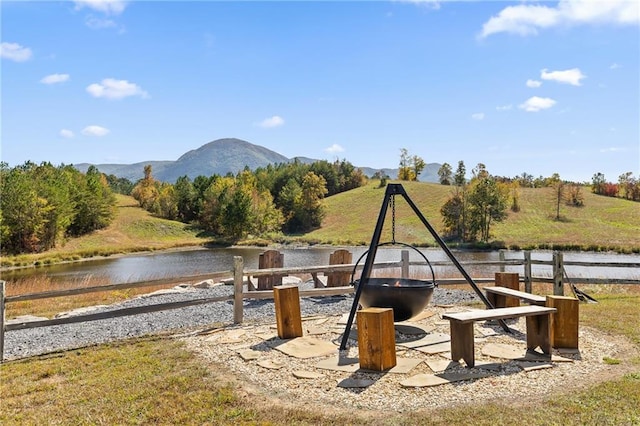 exterior space with a water and mountain view