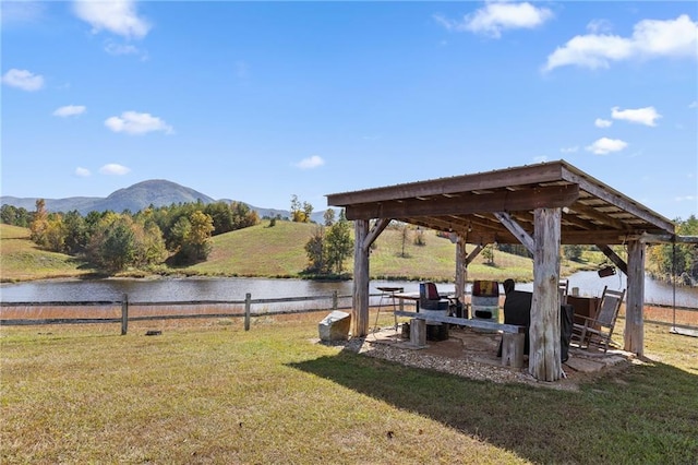 view of yard featuring a water and mountain view