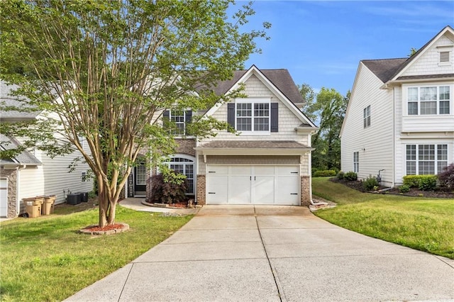 view of front of home with brick siding, driveway, a front lawn, and an attached garage