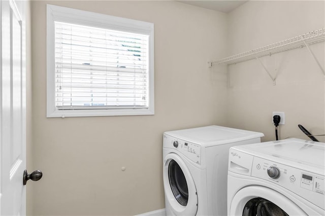 laundry area with independent washer and dryer and healthy amount of natural light
