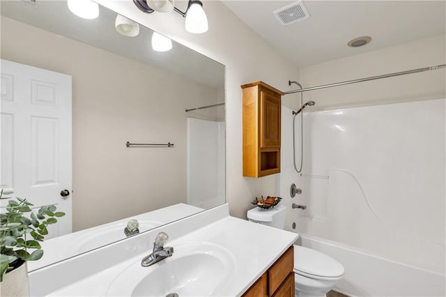 bathroom featuring toilet, vanity, and shower / bath combination