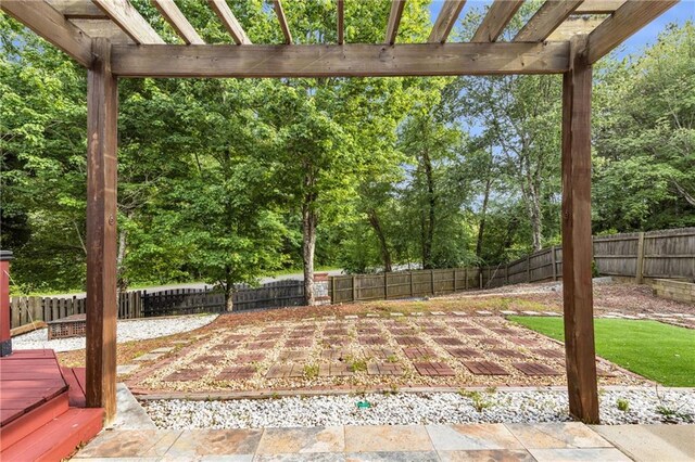view of patio with a pergola, a fenced backyard, and view of scattered trees