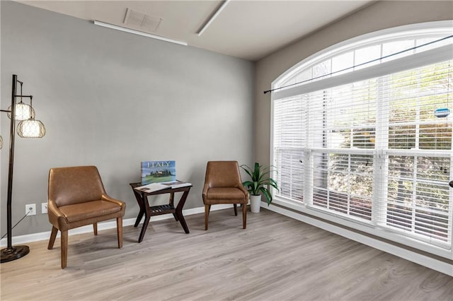 sitting room featuring light wood finished floors and baseboards