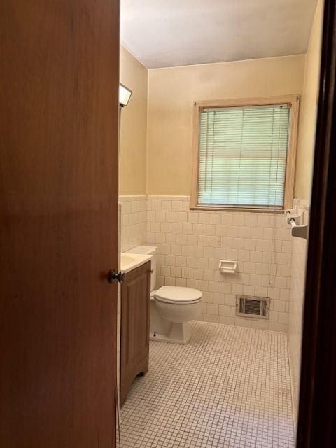 1902 Godby Rd, Atlanta, GA 30349 - bathroom featuring vanity, tile patterned flooring, toilet, and tile walls